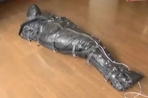 Ballgagged asian girl tied into a leather sleepsack teased and vibed
